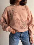 Maglione rosa con decorazioni